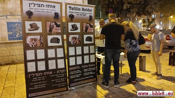 Dieses Foto aus dem Zentrum Jerusalems zeigt, was heutzutage auf den Straßen Israels ganz normal ist:
Männer mit Kippa bieten Passanten an, Tefillin auf Kopf und Hände zu legen und das Schma-Jisrael-Gebet zu sprechen, womit sie eines der 613 Gebote der Thora erfüllen.