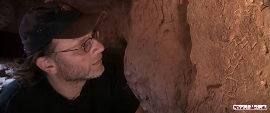 Frame from the film 'The Exodus Decoded'. Images of a fish, water, and a bull's head are visible on the rock. In modern Hebrew, the shapes have changed, but originally, thousands of years ago, they looked like the images on this rock. For example, the first letter of the alphabet is called Aleph, meaning 'bull' in ancient Hebrew, and it can be seen on this rock. The letter M in Hebrew, from the word Ma'im (water), is depicted on the rock as a wave.